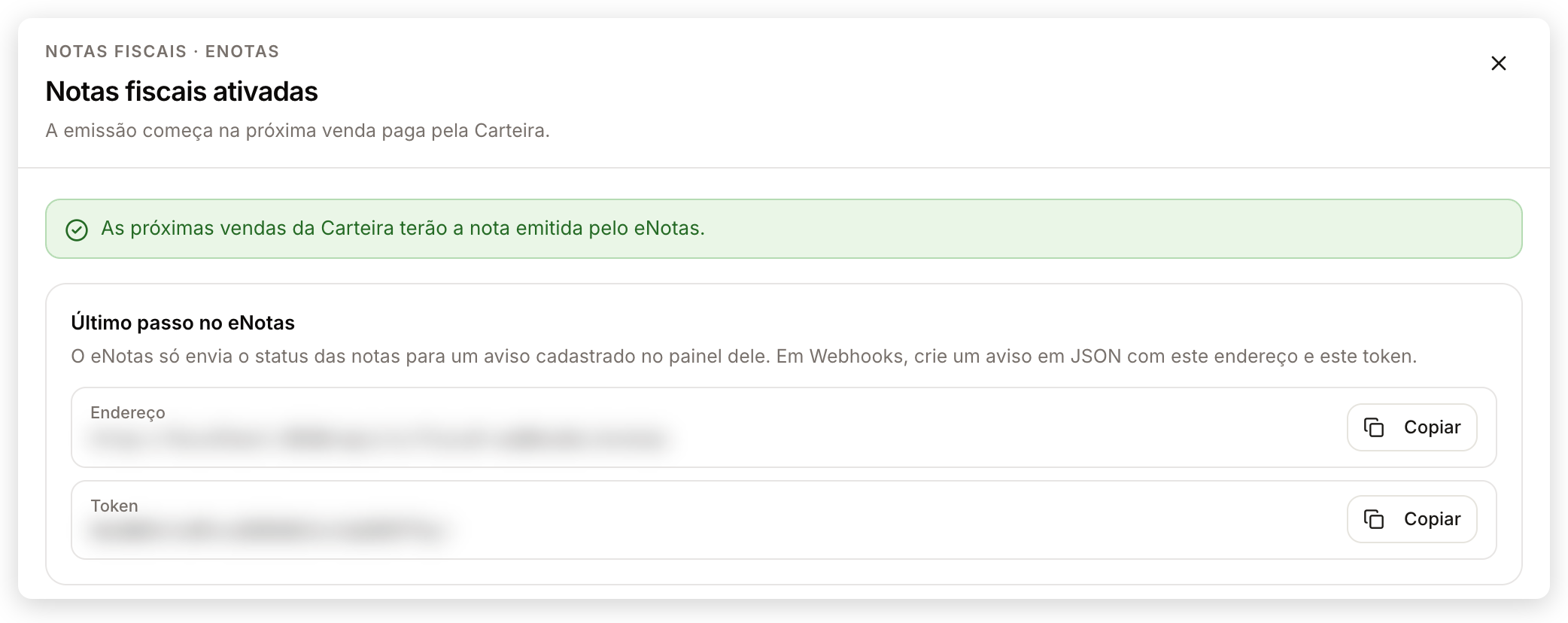 Tela Notas fiscais ativadas com o quadro Último passo no eNotas, que mostra o Endereço e o Token do aviso com botões Copiar